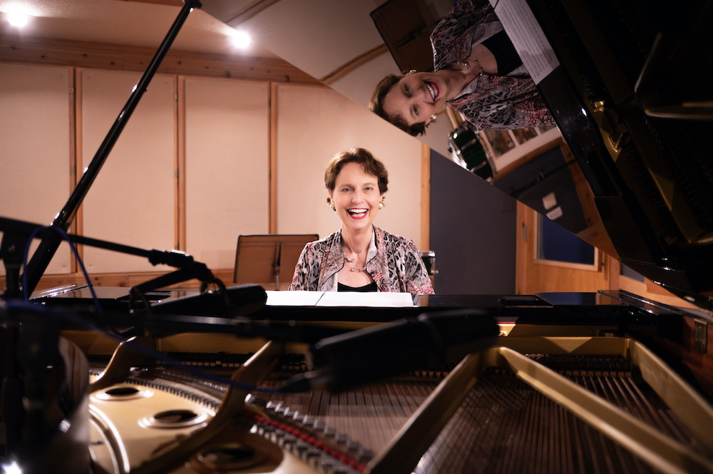 Monika_Herzig_photo_Smiling_from_inside_Piano_copyright_2025_by_Sarah_Slover_copy_2.jpg