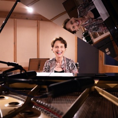 Monika_Herzig_photo_Smiling_from_inside_Piano_copyright_2025_by_Sarah_Slover_copy_2.jpg